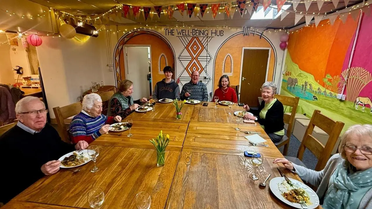 A long table set for a shared community meal