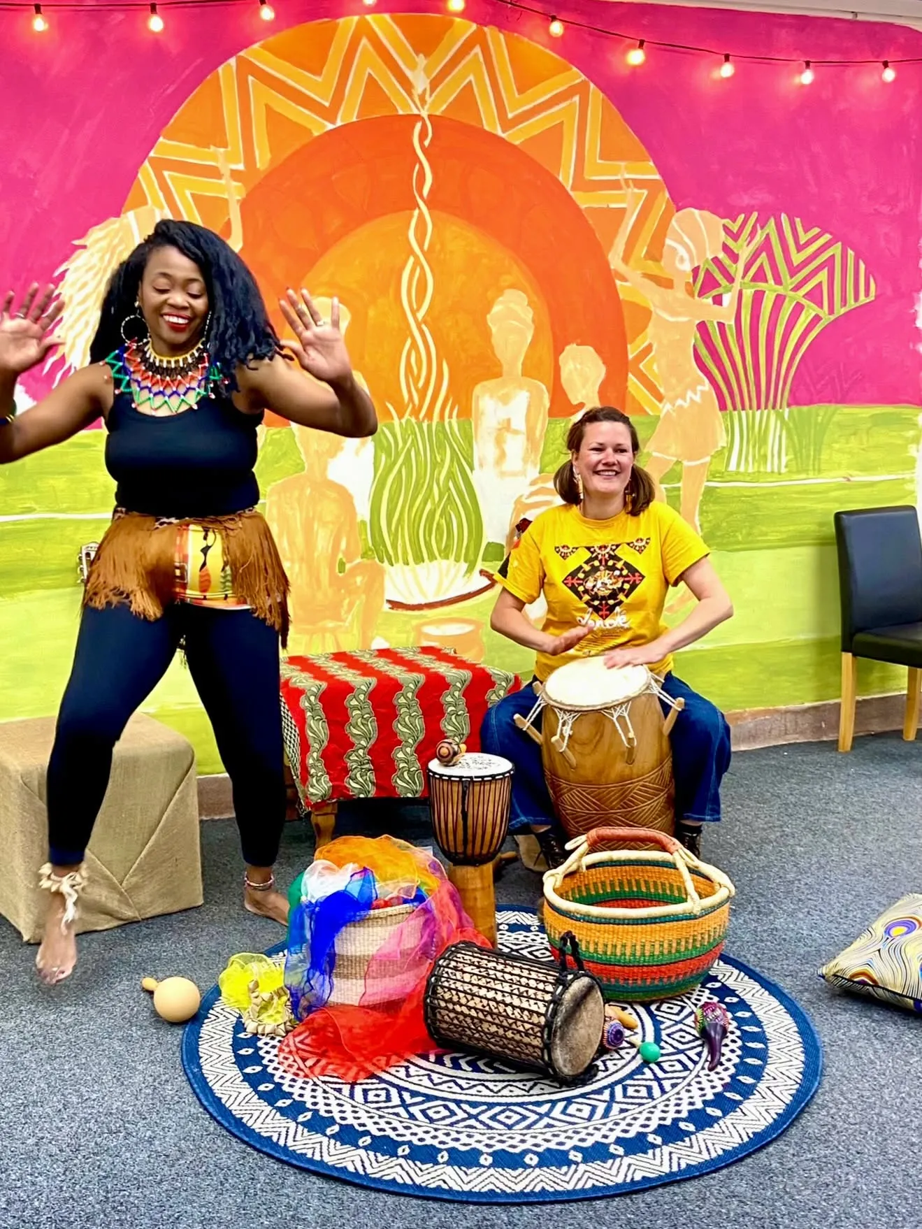 Dancers mid-movement at an African dance session at The Wellbeing Hub