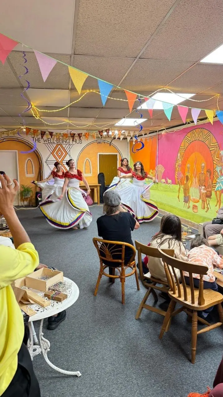 Dancers performing to a seated audience in the main room