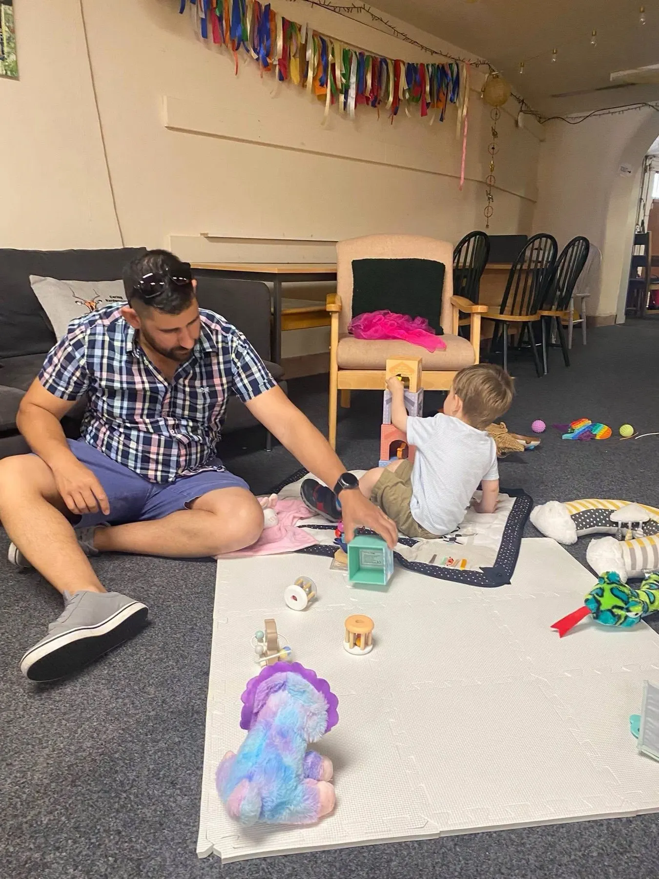 A parent and toddler playing together at a Hub family session