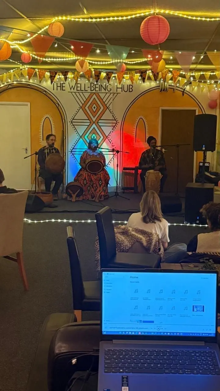 Musicians playing to a seated audience under the lights