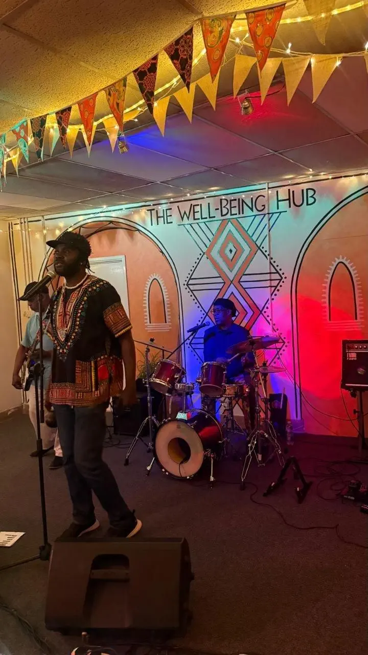 A singer performing to the room at The Wellbeing Hub