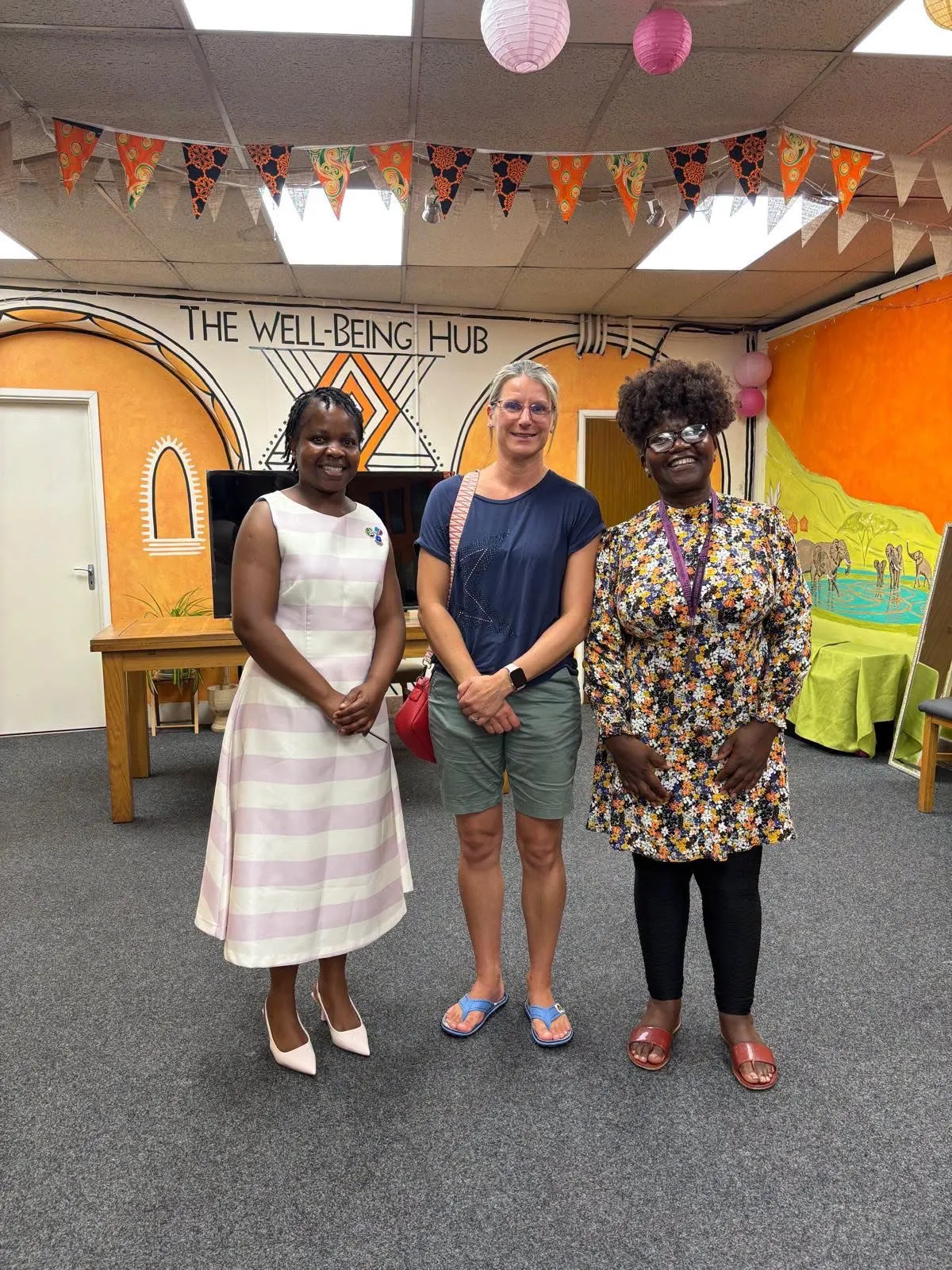 Members of The Wellbeing Hub team welcoming visitors in the community space