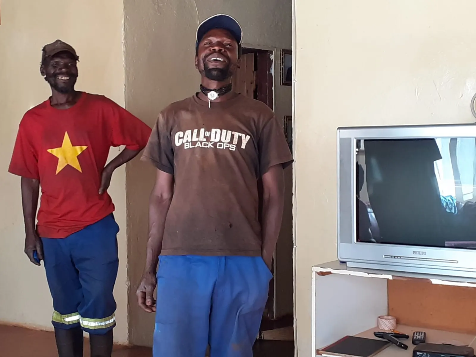 Two men sharing a laugh together in a home in rural Zimbabwe